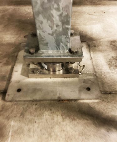 Weight at the base of the supporting structure