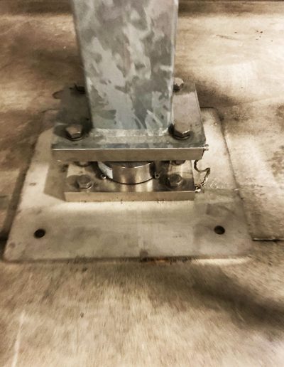 Weight at the base of the supporting structure