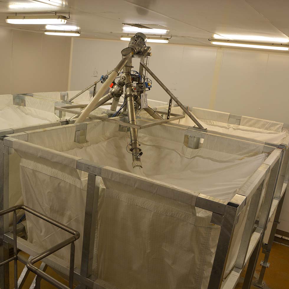 Flexible screw conveyor transferring bulk products to flexible silos